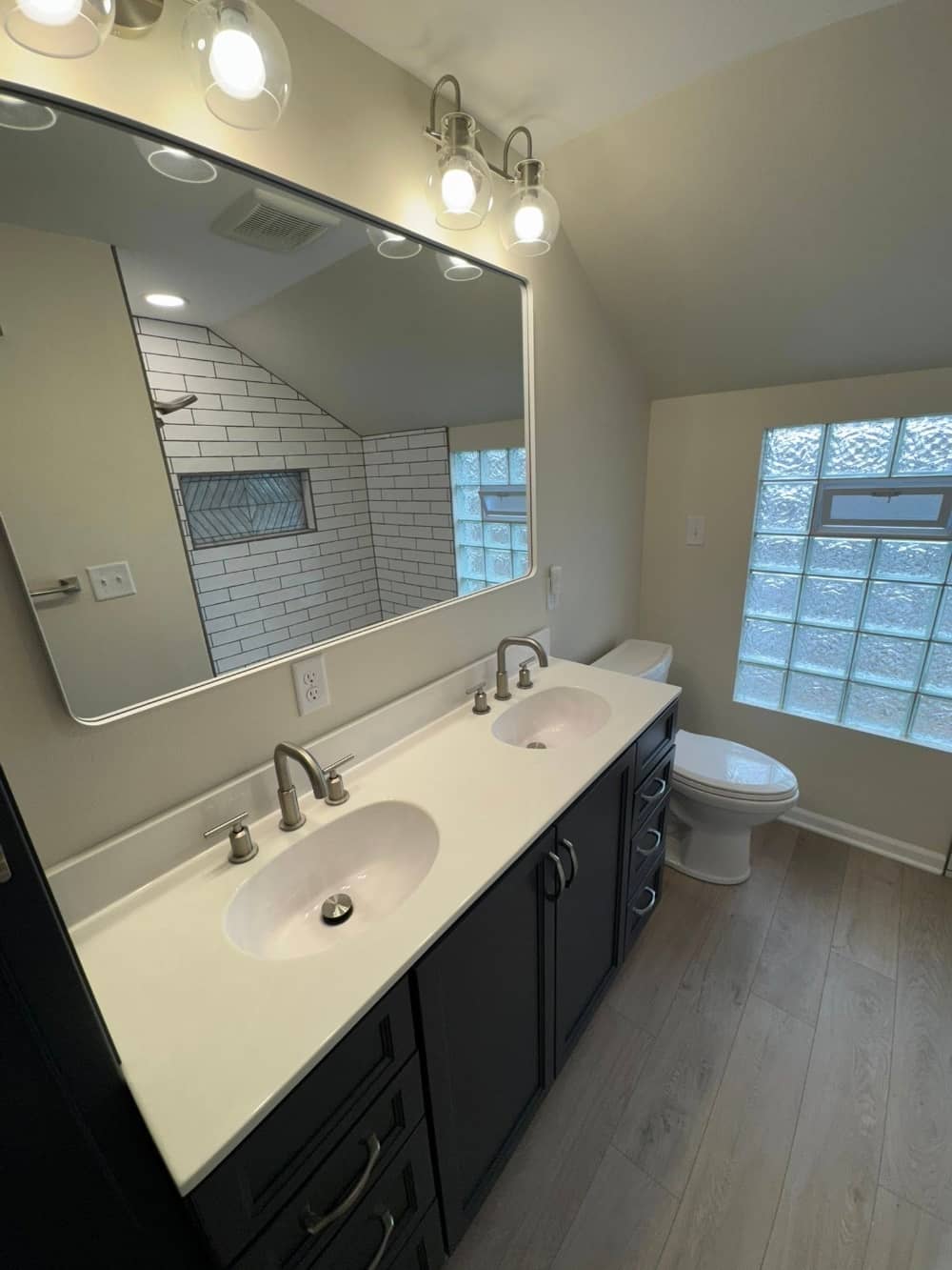 bathroom renovation with new sink and mirror and flooring